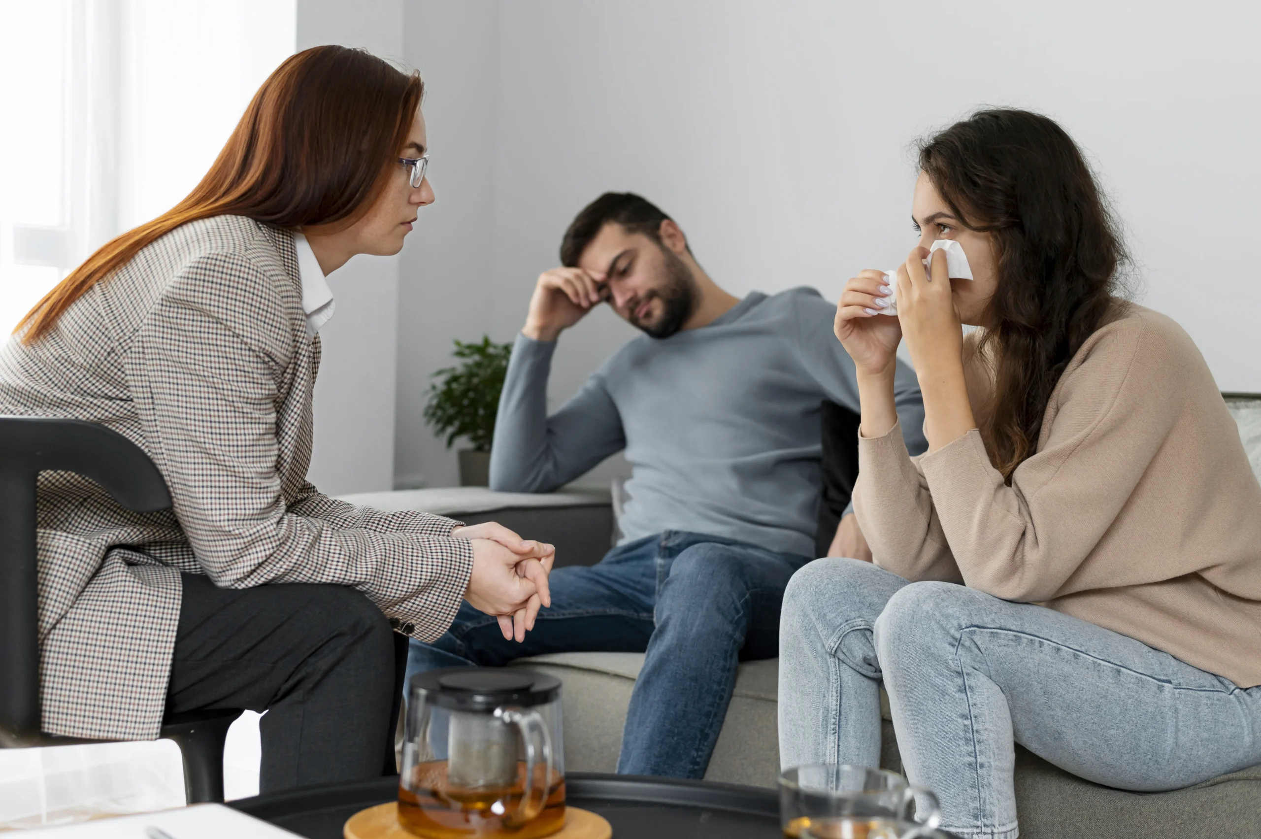 "Couple in therapy with a counselor, showing emotional distress, highlighting the importance of support for what is the mental illness they are experiencing
