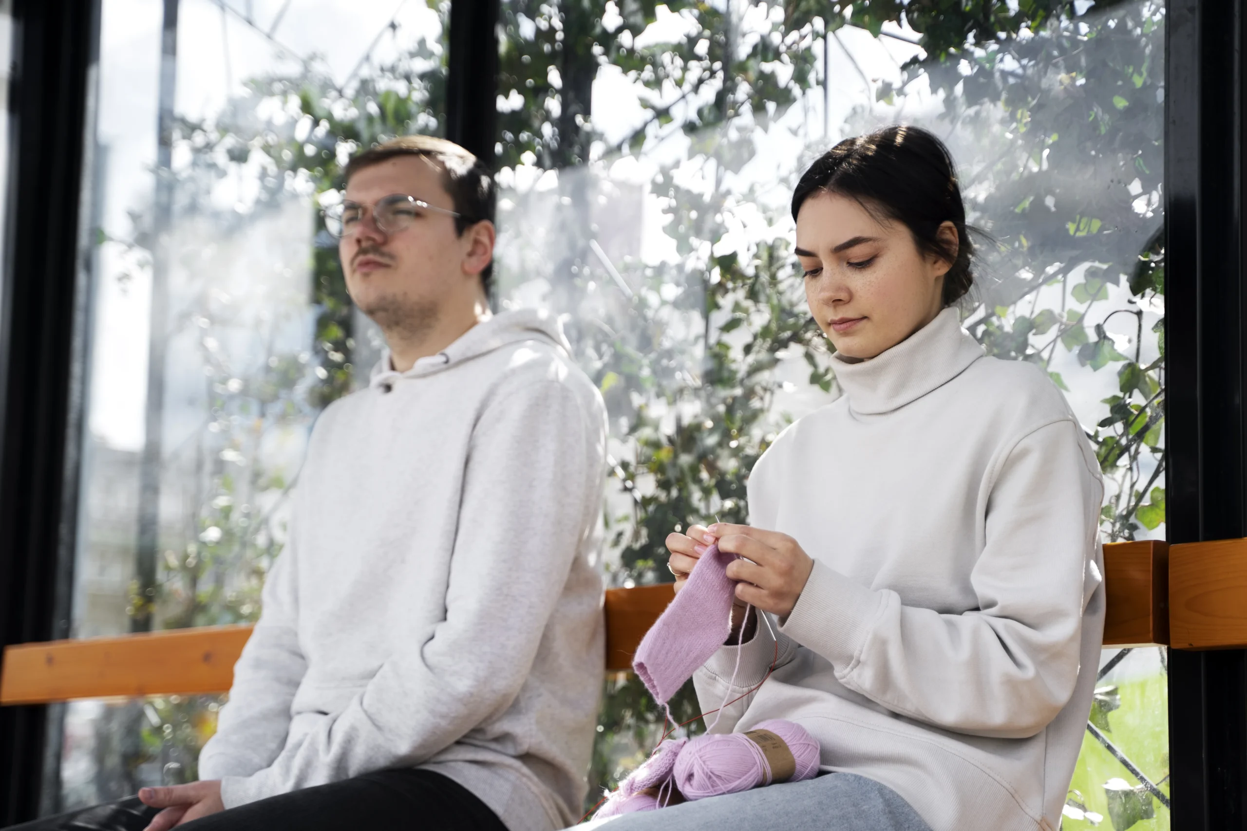 Young adults practicing calm daily activities like knitting and mindfulness, highlighting what are some issues that affect spiritual health such as stress, focus, and emotional balance
