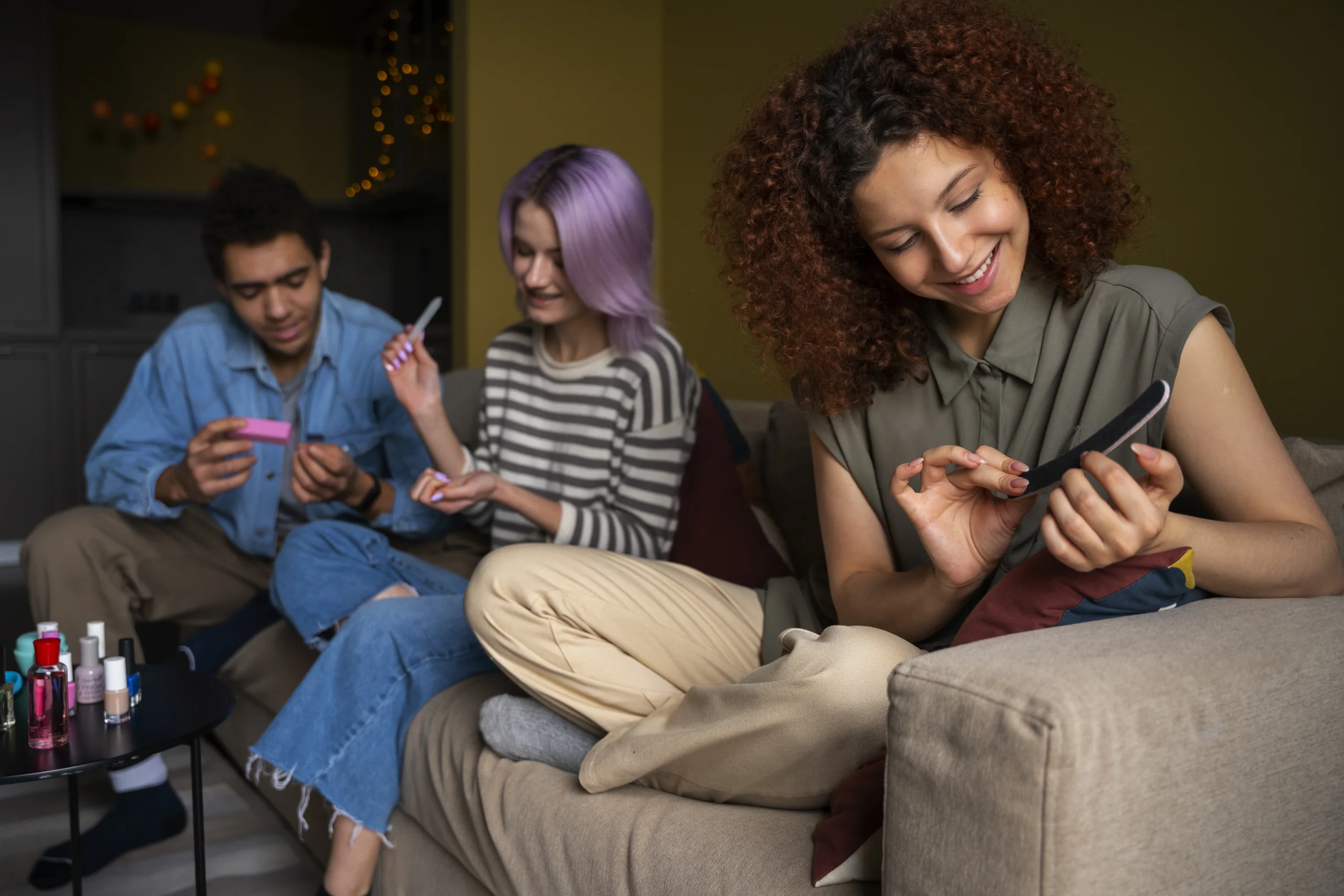 A group of friends enjoying a manicure session, with nail products on a table. This relaxed moment reflects the importance of self-care, aligning with the rise of digital mental health apps for stress relief and wellness.