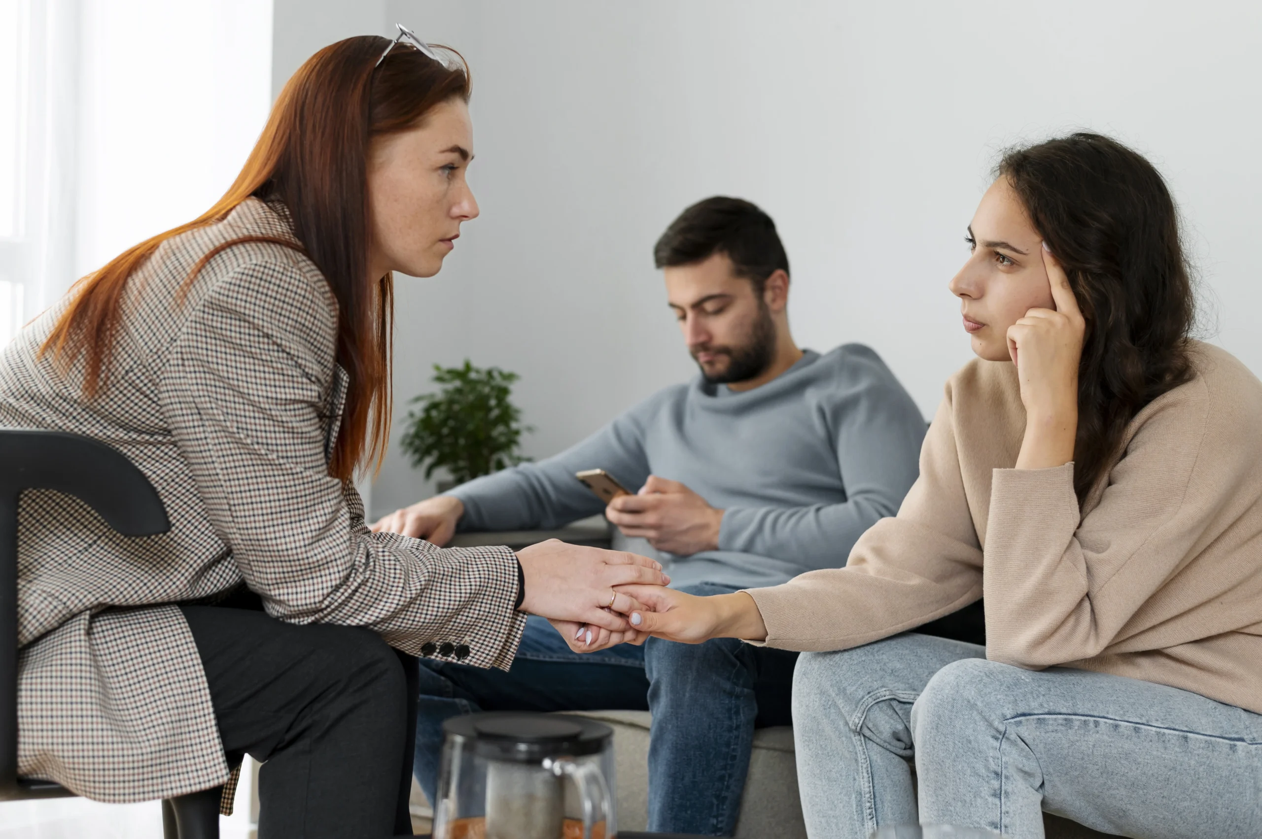 Therapist supporting young woman during counseling session showing signs your mental health is declining and emotional distress in modern home setting